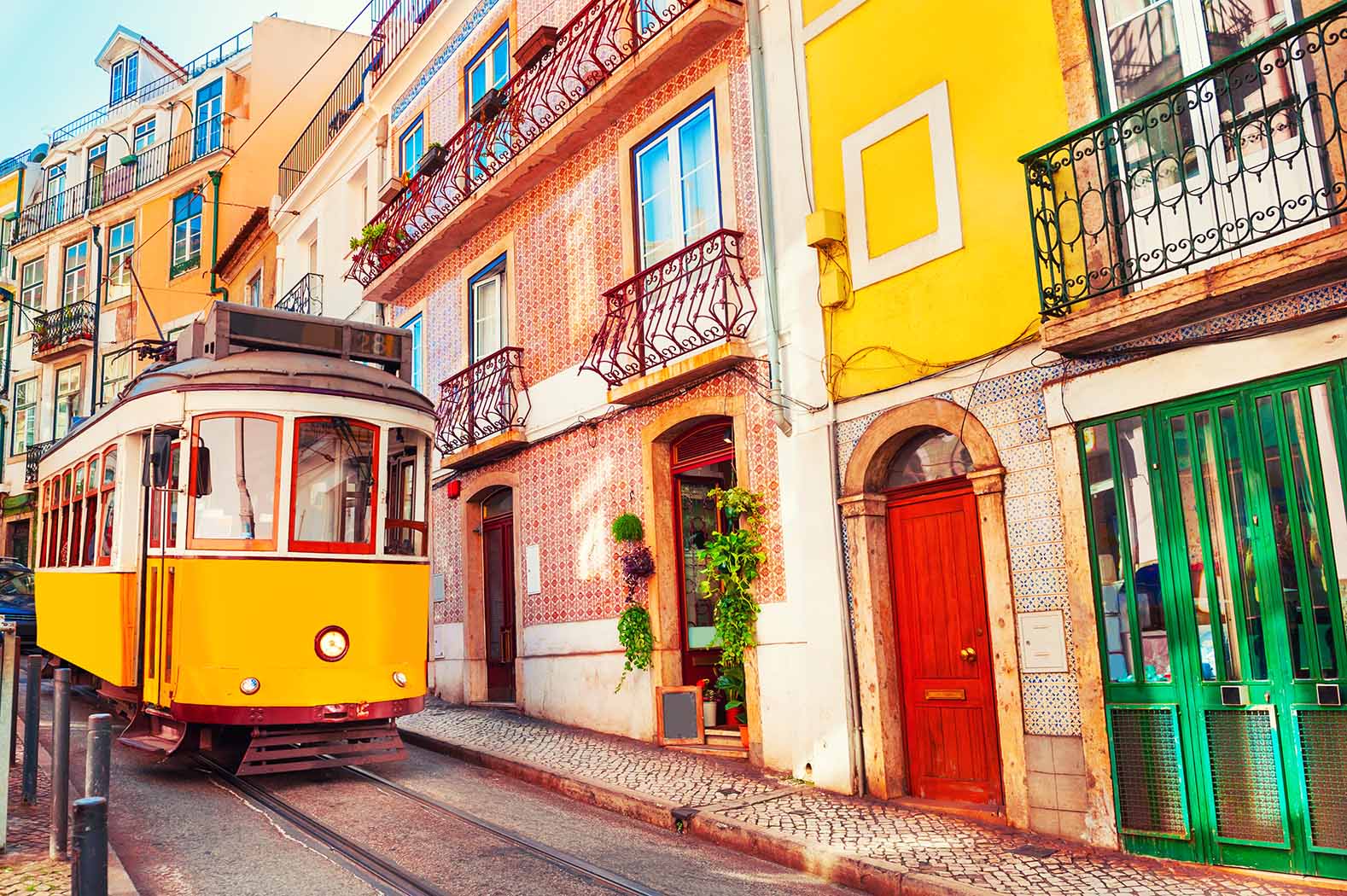 tram and colorful neighborhood in Lisbon.