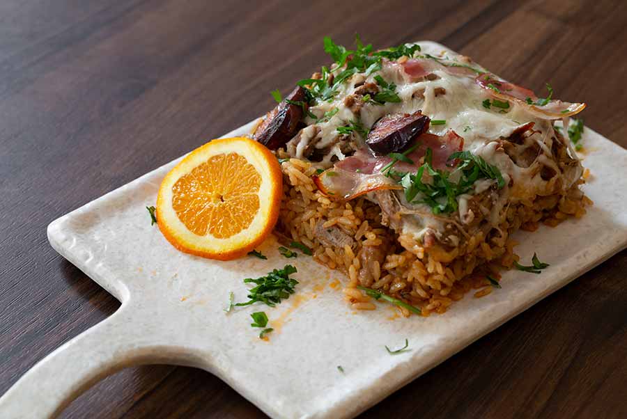 guest enjoying plate of Duck Rice, Arroz de Pato, in Braga,