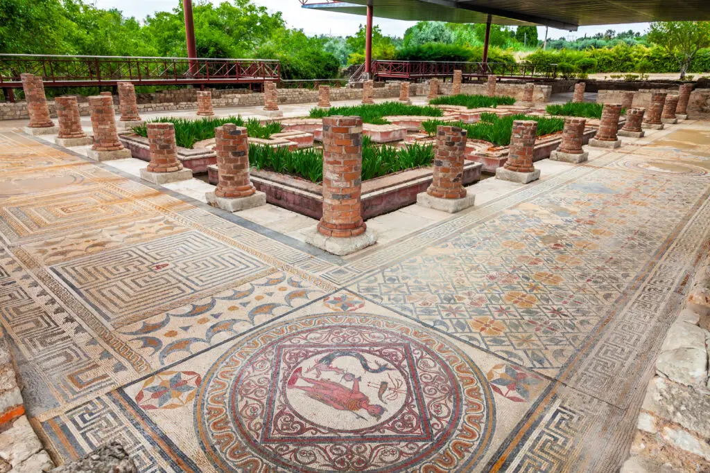 Intricate Roman mosaics and garden courtyard at the House of the Fountains in Conimbriga, ancient Roman ruins near Coimbra, Portugal