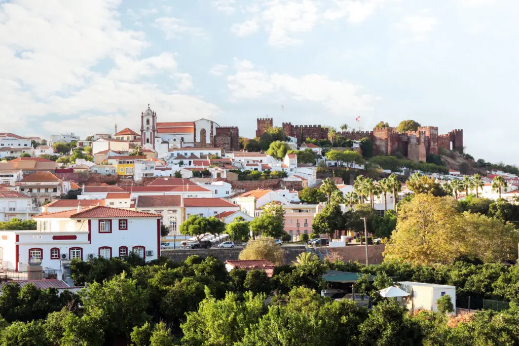 Scenic view of the old town of Silves with historic cathedral and Castelo de Silves fortress in the Portimão region, Algarve, Portugal