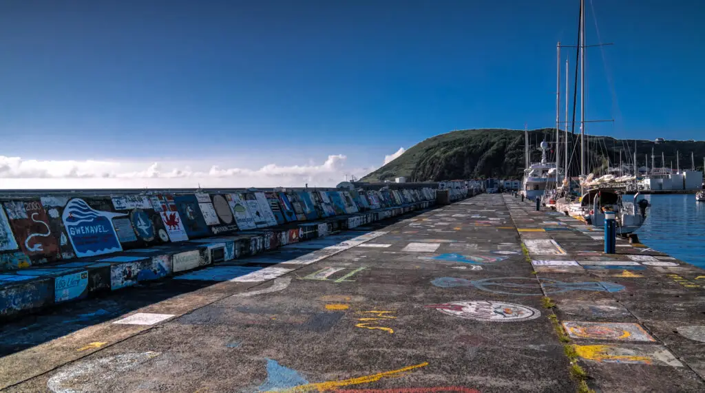 Colorful painted pier and yachts in Horta harbour on Faial Island, Azores, Portugal, a popular stop for sailors and tourists exploring the Atlantic islands