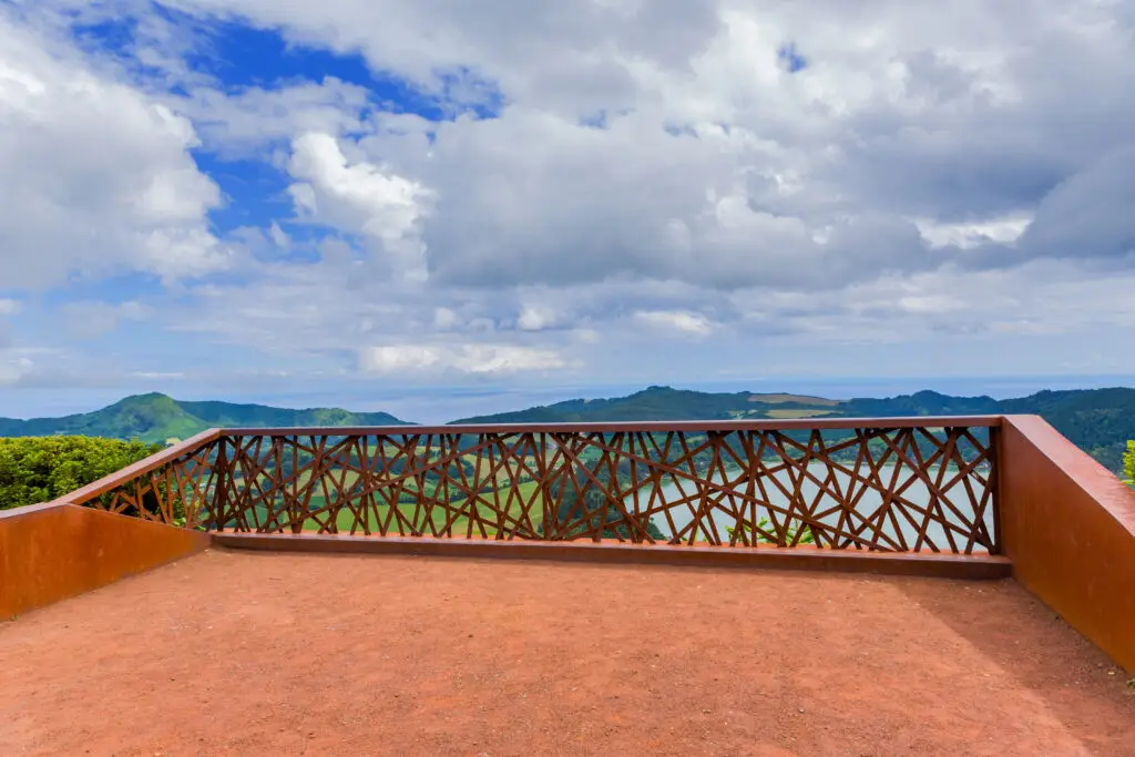 Scenic viewpoint at Pico do Ferro in São Miguel Island, Azores, Portugal overlooking Furnas Valley and lush green mountains under a cloudy sky