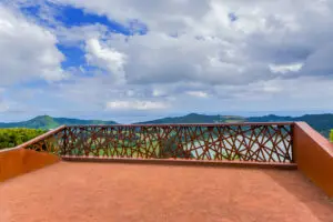 Scenic viewpoint at Pico do Ferro in São Miguel Island, Azores, Portugal overlooking Furnas Valley and lush green mountains under a cloudy sky