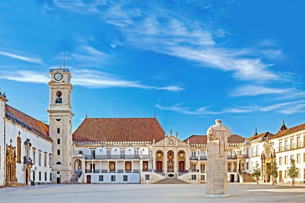Historic courtyard and clock tower of the University of Coimbra in Portugal, a UNESCO World Heritage Site and popular destination for cultural and educational tours