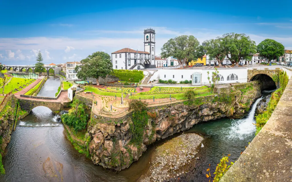 Central square of Ribeira Grande with Ponte dos Oito Arcos bridge, river, waterfall, and historic buildings on São Miguel Island in the Azores, Portugal