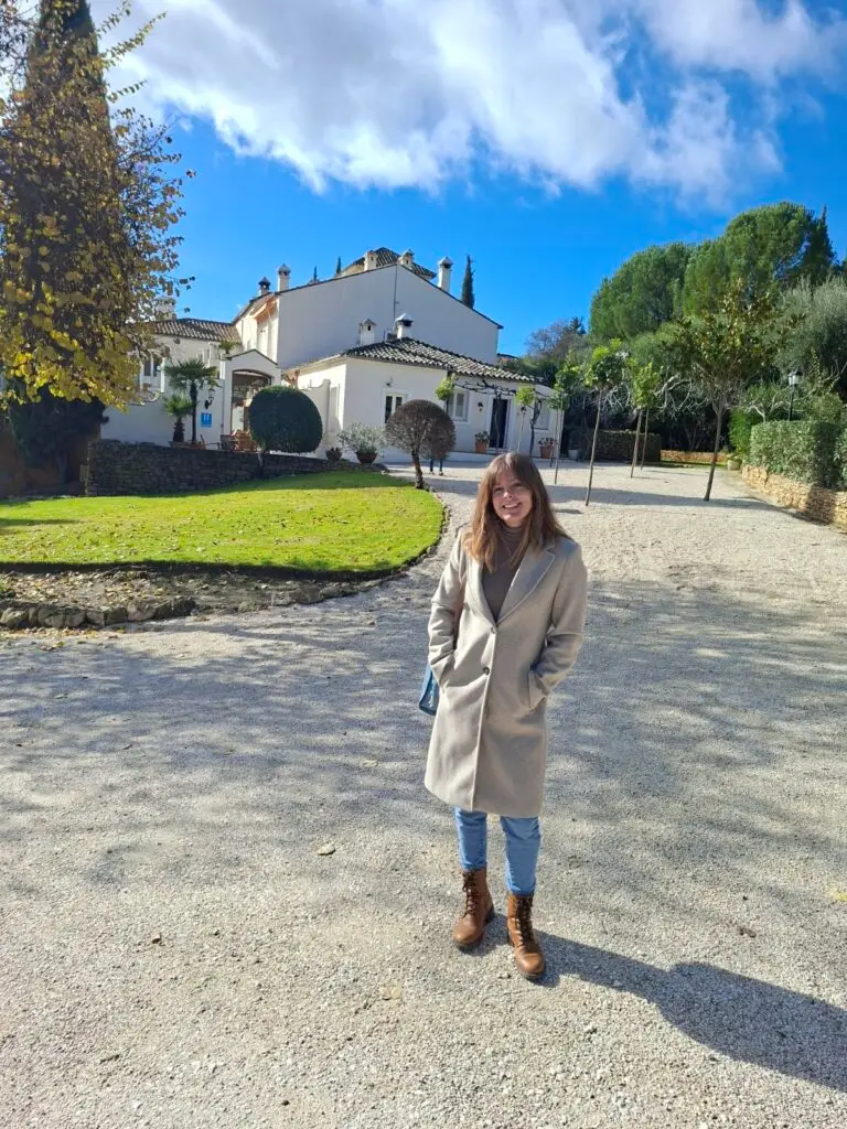 Tour guide standing in front of a scenic Portuguese villa on a sunny day during a Private Portugal Tour