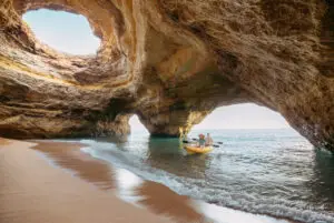 Couple kayaking inside the Benagil sea cave on the Algarve coast in Portugal during a private tour