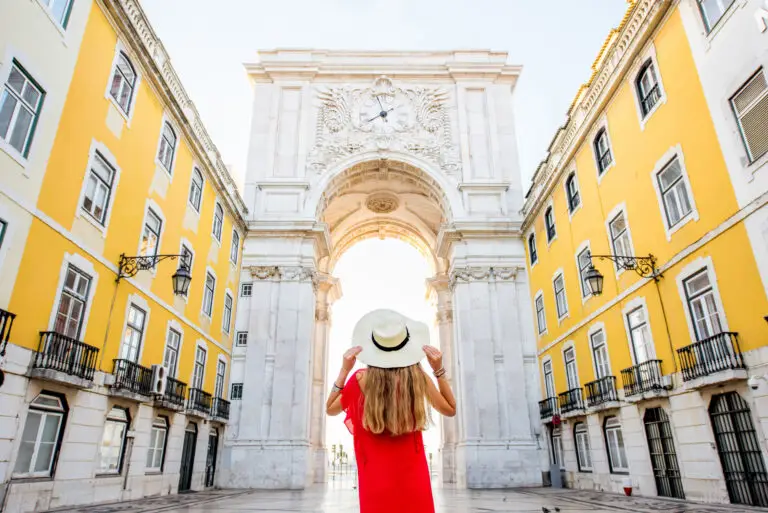 Woman enjoying a sightseeing tour at Arco da Rua Augusta in Lisbon Portugal