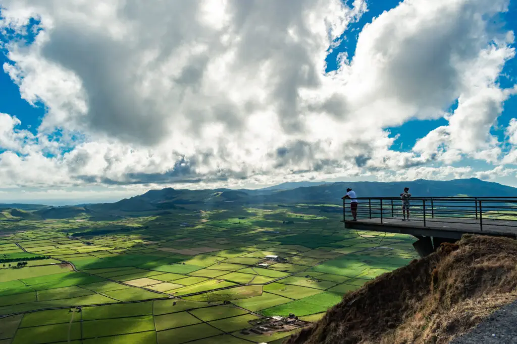 Serra do Cume viewpoint with silhouette of two people with fantastic cloudy sky, Terceira, Azores, Portugal