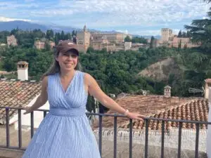 Smiling woman enjoying scenic view of historic castle and lush hills in Portugal during a private guided tour