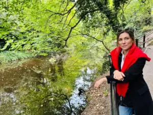 Tour guide Cristina by a peaceful river surrounded by lush green trees during a Private Portugal Tour