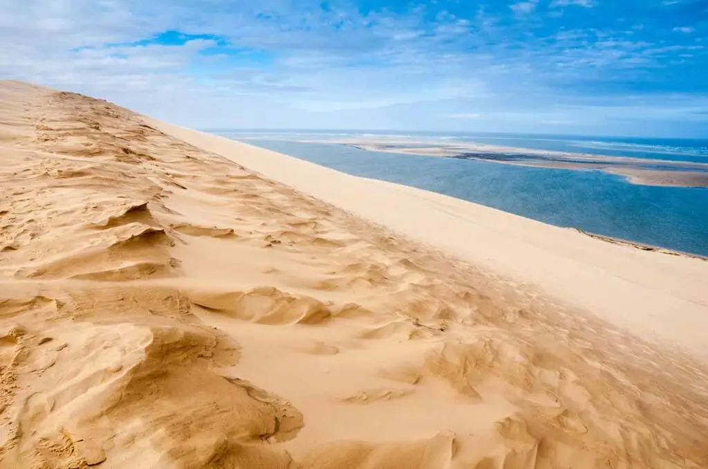 Golden sand dunes of the Dune of Pyla overlooking the Atlantic Ocean in Arcachon, France, a popular natural attraction and travel destination