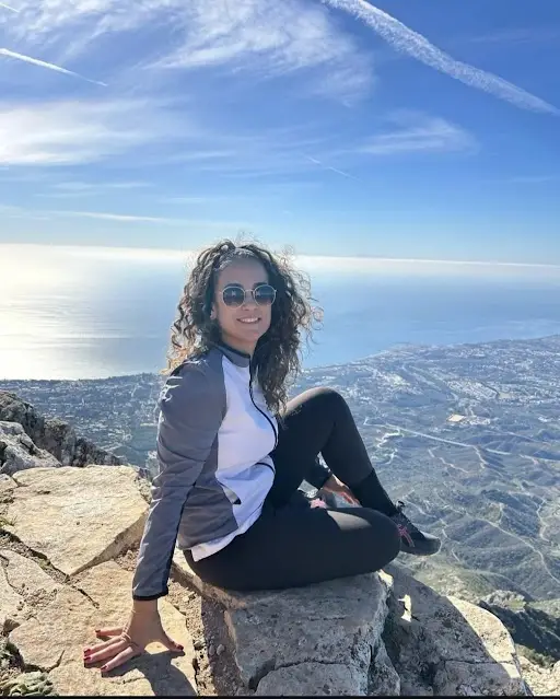 Woman enjoying scenic mountain view overlooking the Portuguese coastline during a Private Portugal Tour