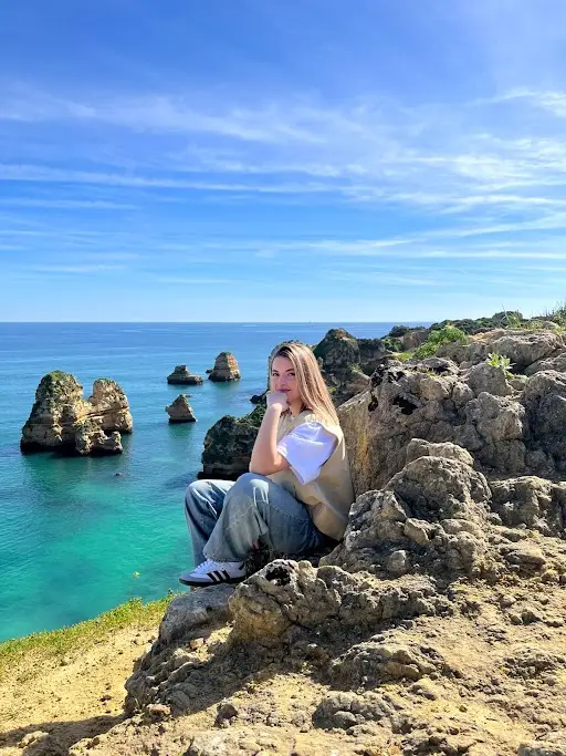 Woman enjoying ocean views at Ponta da Piedade cliffs in Lagos Algarve Portugal during a Private Portugal Tour