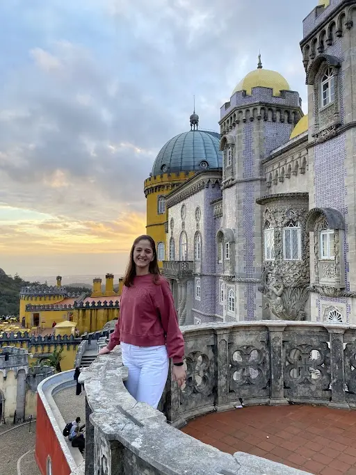 Tourist enjoying the view at Pena Palace in Sintra Portugal during a private Portugal tour at sunset