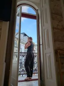 Tour guide standing on a balcony in Lisbon Portugal enjoying the city view for Private Portugal Tours profile photo