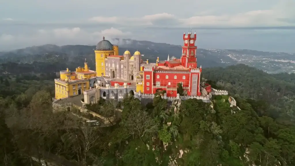 Colorful Pena Palace in Sintra surrounded by lush forest and mountain views, a top Portugal tourist attraction featured on the Private Portugal Tours homepage